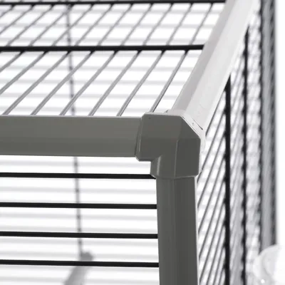 Close-up view of an enclosure with metal mesh walls and plastic frame.