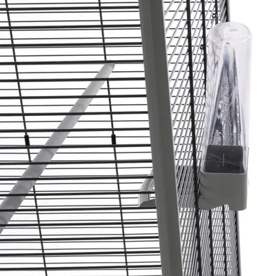 Close-up view of a cage with metal mesh walls and a transparent water bottle attached to the outside of the mesh.