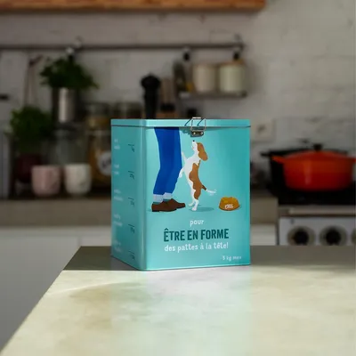 Boîte de stockage turquoise avec illustration de chien et humain, texte : 'Pour être en forme des pattes à la tête !' Capacité maximale : 5 kg.