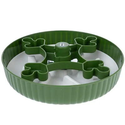 Green anti-gulp bowl made of plastic with bone-shaped obstacles for slow food intake.