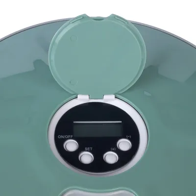 Electronic control panel with buttons for On/Off, Set and (+/-) on a green device. Flip lid open.