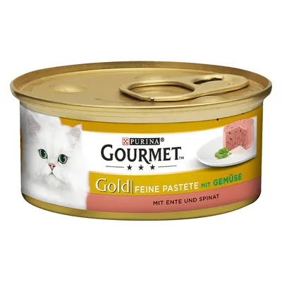 Purina Gourmet Gold Feine Pastete mit Gemüse, mit Ente und Spinat -kissan märkäruokapurkki. Etiketissä valkoinen kissa ja annos pateeta lautasella.
