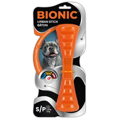 BIONIC Urban Stick Baton, oranje, voor honden tot 9 kg. Sterkte-indicator: mild, strong, bionic. Verpakking toont hondenafbeelding en productdetails.