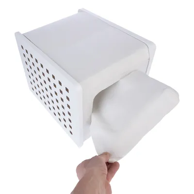 Hand pulls a white cushion from a white perforated box. Product shows functionality and design.