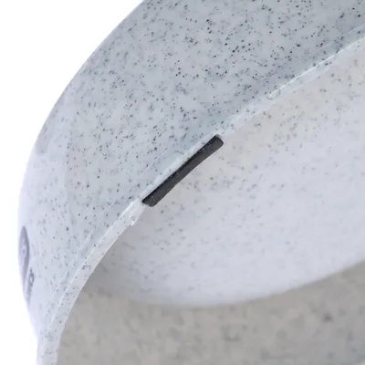 Close-up of a grey, speckled plastic bowl with a black rubber rim insert.