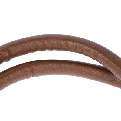 Primo piano di una maniglia in pelle marrone imbottita. Struttura del materiale visibile.