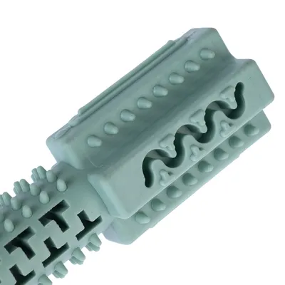 Green rubber chew toy with studs and zigzag pattern for dental cleaning.