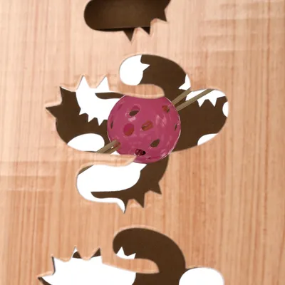Wooden toy with animal-shaped cutouts and a pink ball held by two wooden rods.