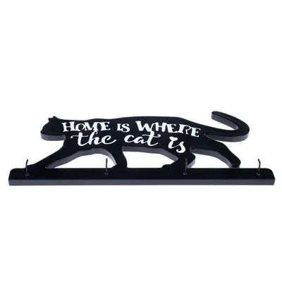 Perchero de pared negro en forma de gato con texto blanco: "Home is where the cat is". Cuatro ganchos para llaves o accesorios.