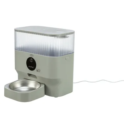 Automatic feeder with stainless steel bowl, transparent container and control elements. Power cable connected.