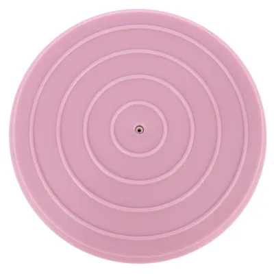 Disco rotondo in plastica rosa con cerchi concentrici e piccolo foro centrale.
