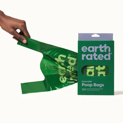 Earth Rated dog waste bags, lavender scented, 120 pieces with handles. Packaging and one removed green bag visible.