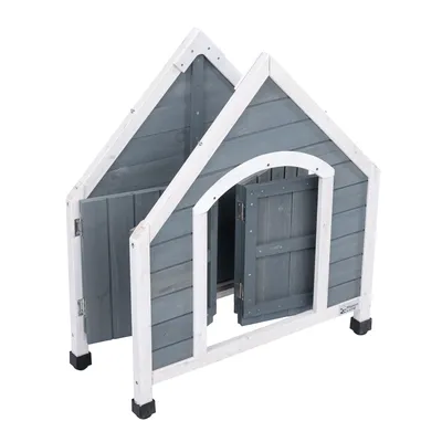 Casota de madeira cinzenta e branca com porta, elevada sobre pés de plástico pretos. Logótipo da marca 'Nomad Tales' visível no canto inferior direito.