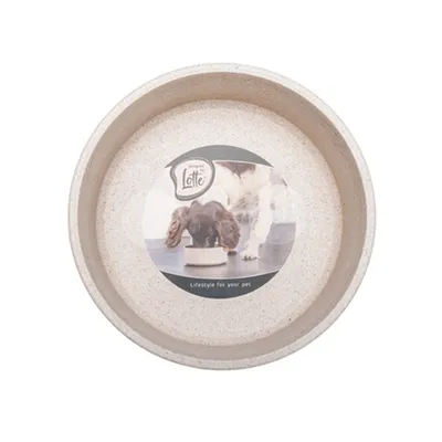 Gamelle beige avec étiquette montrant un chien mangeant, texte visible : Designed by Lotte, Lifestyle for your pet.