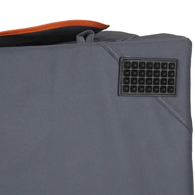 Close-up of a grey fabric product with an orange trim and a black rubber non-slip base detail in the corner.