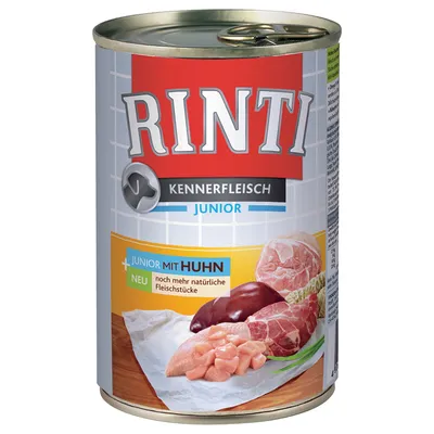 Conservă Rinti Kennerfleisch Junior, text vizibil: Junior mit Huhn, imagini cu carne crudă și organe pe etichetă. Text suplimentar în germană: noch mehr natürliche Fleischstücke.