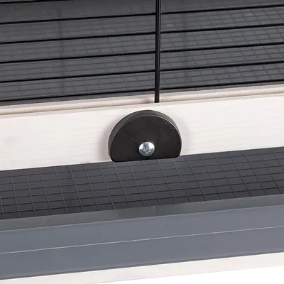 Close-up view of a black grid lock with wooden frame and plastic base.