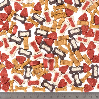 Various dog snacks in bone, heart and rectangle shapes, assorted colours. Scale at the bottom shows sizes in centimetres.