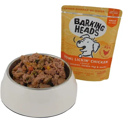 Barking Heads Bowl Lickin' Chicken adult food pouch with visible blend of chicken, garden vegetables and herbs served in a bowl. Grain-free, 85% free run chicken, natural ingredients.