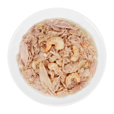 Hvid skål med vådfoder bestående af lyse kødstrimler og hele rejer i gelé eller sauce, set oppefra. Ingen synlige mærker eller tekst.