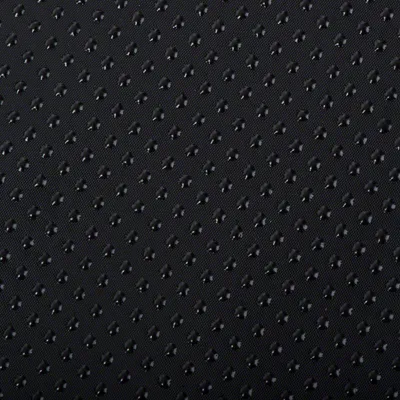 Close-up of a black, non-slip material with small studs for better grip.