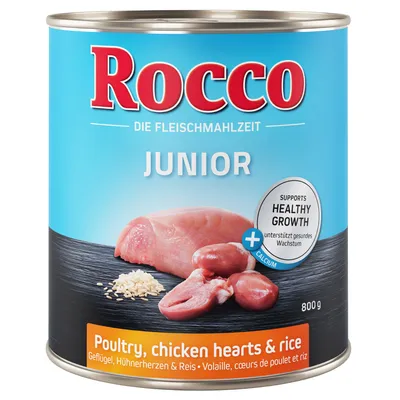 Консерва Rocco Junior, 800 г. Видны кусок мяса, куриные сердца и рис. Текст: Poultry, chicken hearts & rice. Надпись на английском: Supports healthy growth, calcium.