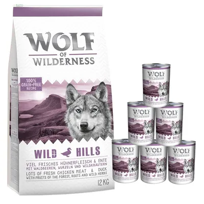 Wolf of Wilderness Wild Hills dry food 12kg bag and six cans. Visible text: 100% grain-free recipe, lots of fresh chicken meat & duck with fruits of the forest, roots and wild herbs.