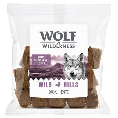 Wolf of Wilderness Wild Hills Duck – Ente, 100% grain-free recipe. Trozos de snack visibles en envase transparente.