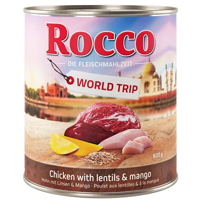 Lata de comida para perros Rocco World Trip, 800 g. Texto visible: Chicken with lentils & mango, Huhn mit Linsen & Mango, Poulet aux lentilles & à la mangue. Ingredientes visibles: carne, mango, lentejas.