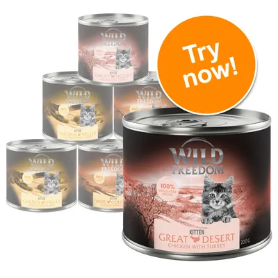 Wild Freedom kitten food tins, visible varieties: Great Desert Chicken with Turkey, Golden Valley Chicken with Rabbit, Wide Country Chicken. 100% grain-free recipe. Orange Try now! badge.