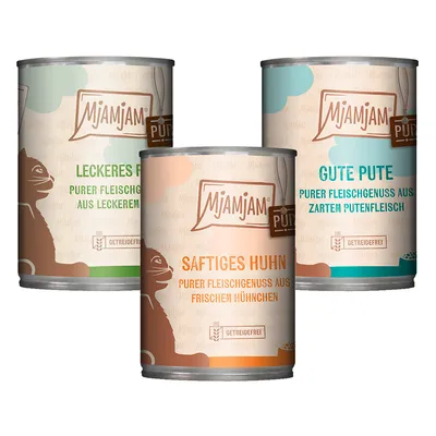 Tres latas de comida para gatos MjAMjAM: Leckeres Rind, Saftiges Huhn y Gute Pute. Etiquetas en alemán, indican 'getreidefrei' (sin cereales). Imagen de un gato en cada lata.