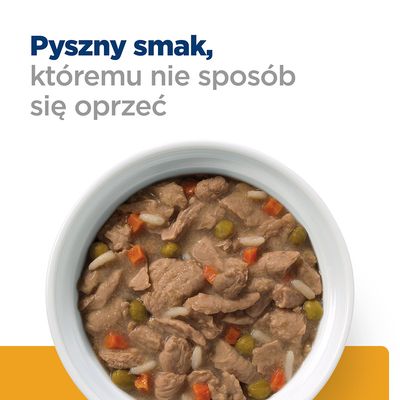 Miska z kawałkami mięsa, marchewką, groszkiem i ryżem w sosie. Widoczny tekst: Pyszny smak, któremu nie sposób się oprzeć.