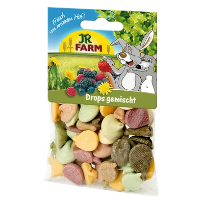 JR Farm Drops gemischt -sekoitus, värikkäitä pieniä nappeja läpinäkyvässä pussissa. Pakkauksessa piirroskanit ja marjakuvia, teksti: Frisch von unserem Hof! Drops gemischt.