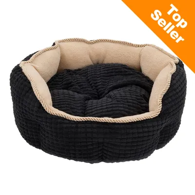 Rund sort og beige hundeseng med blød tekstiloverflade. Synlig orange hjørne med teksten 'Top Seller'.