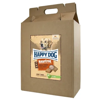 Caja de cartón con etiqueta visible: Happy Dog NaturCroq Müsli-Ecken. Imagen de un perro y galletas en la etiqueta. Texto adicional: OHNE, Natural Life Concept. Caja de cartón con etiqueta visible: Happy Dog NaturCroq Müsli-Ecken. Imagen de un perro y galletas en la etiqueta. Texto adicional: OHNE, Natural Life Concept.