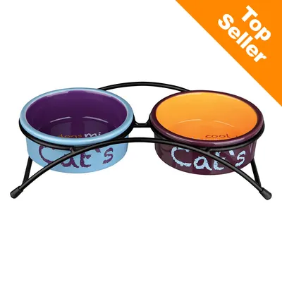 Dwie miski ceramiczne na stojaku z napisem Cat's, jedna niebiesko-fioletowa, druga pomarańczowo-fioletowa. Napis w rogu: Top Seller.
