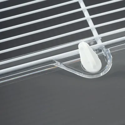 Close-up of a white plastic fastener on a wire cage with transparent holder.