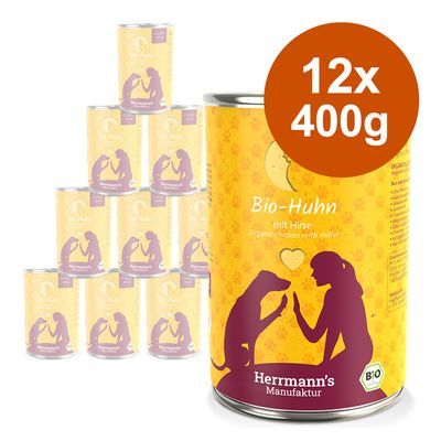 Herrmann's Manufaktur Bio-Huhn mit Hirse, 12 blikken à 400g. Gele verpakking met paarse silhouetten van hond en persoon, zichtbaar BIO-keurmerk.