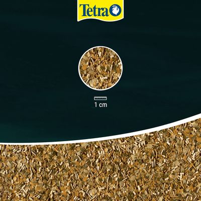 Tetra. Close-up of food flakes with scale, showing particle size of 1 cm.