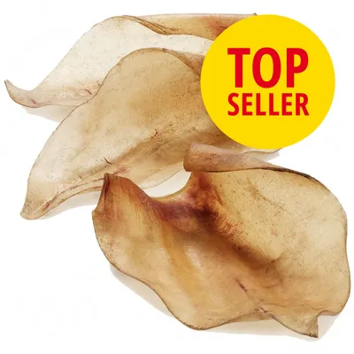 Tørrede griseører til hunde, tre stykker vist. Gul cirkel med rød tekst: TOP SELLER.