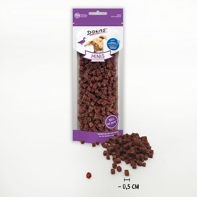 Zak Dokas Minis hondensnacks, transparant met paarse details, zichtbaar blokjes van ca. 0,5 cm, tekst: 'MINIS', 'ROZE NEK KUIF'. Hond en struisvogel afgebeeld op verpakking.
