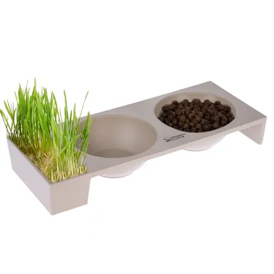 Estación de alimentación con dos cuencos y compartimento integrado para hierba gatera, marca Modern Home.