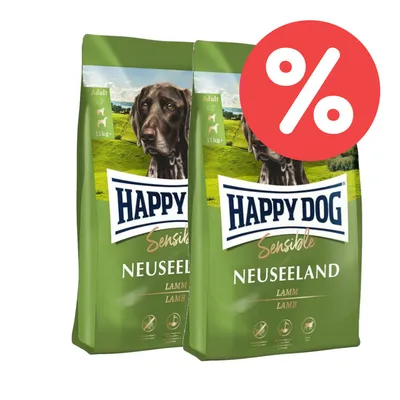 Happy Dog Sensible Neuseeland Lamm, Adult, 11kg. Zwei grüne Verpackungen mit Hundebild und rotem Prozent-Symbol für Rabatt.