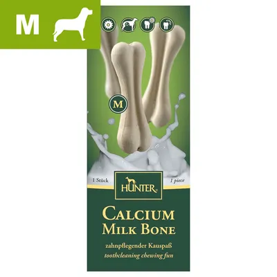 Hunter Calcium Milk Bone, størrelse M, 1 stk. Synlig tekst: toothcleaning chewing fun, zahn­pflegender Kau­spaß. Billede af tyggeben og mælkestænk.