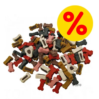 Blandade hundgodisbitar i olika färger och former, benformade. Gul cirkel med röd procenttecken visar rabatt eller specialerbjudande. Blandade hundgodisbitar i olika färger och former, benformade. Gul cirkel med röd procenttecken visar rabatt eller specialerbjudande.