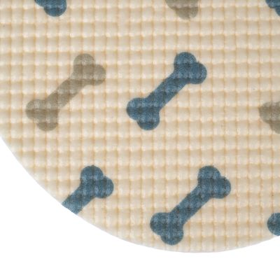 Primer plano de una superficie beige texturizada con patrones de huesos azules y grises.