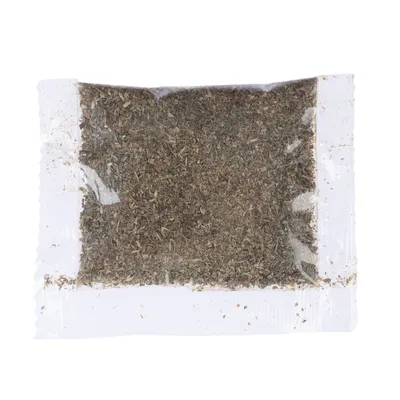 Transparent pouch with dried herbs, visible through the packaging.
