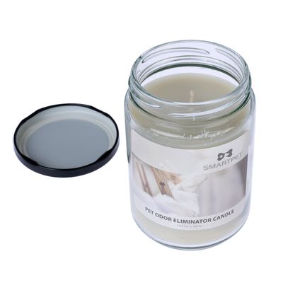 Bougie en pot en verre avec couvercle, étiquette visible : SMARTPET PET ODOR ELIMINATOR CANDLE FRESH LINEN. Bougie blanche non allumée.