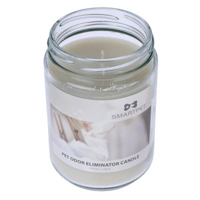 Bougie en pot en verre, étiquette visible : SMARTPET, PET ODOR ELIMINATOR CANDLE, FRESH LINEN. Bougie de couleur crème non allumée.
