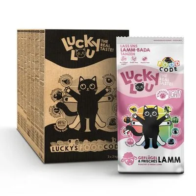 Lucky Lou kattenvoer verpakking en doos, zichtbaar: 'The real taste!', 'Geflügel & frisches Lamm', illustratie van zwarte kat met symbolen, 97% vlees, zonder granen. Tekst deels in Duits.